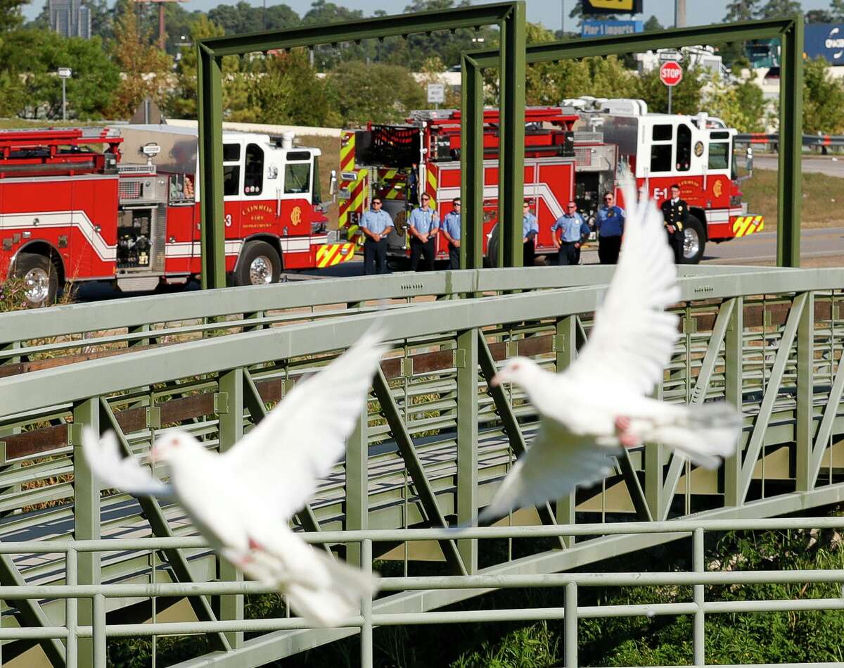 Conroe firefighters are seen as doves are released in remembrance of first responders during a ceremony at the Montgomery County Veterans Memorial Park in honor of the 20th anniversary of the 9/11 terrorist attacks, Saturday, Sept. 11, 2021, in Conroe.