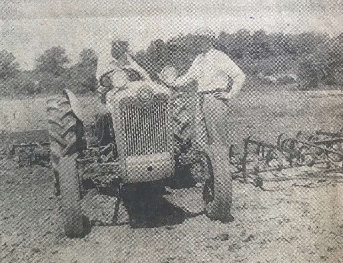 A crew of about 40 men from the Dow agricultural chemical labs is in charge to keep up the grounds. Their main job, however, is at the Dow experimental farm adjacent to the Victory Gardens. Jack Eastman, right, is in charge of taking care of the field work at the gardens. Vikor Stachowiak, at left, is the crew leader. July 1957