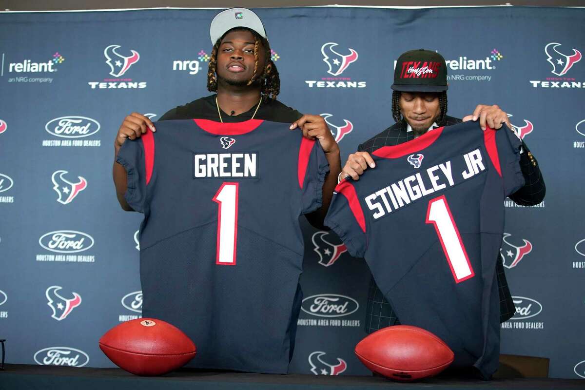 Kenyon Green, left, and Derek Stingley Jr, right, hold up their jerseys during the Houston Texans introductory press conference for their first two draft picks at NRG Stadium on Friday, April 29, 2022 in Houston.
