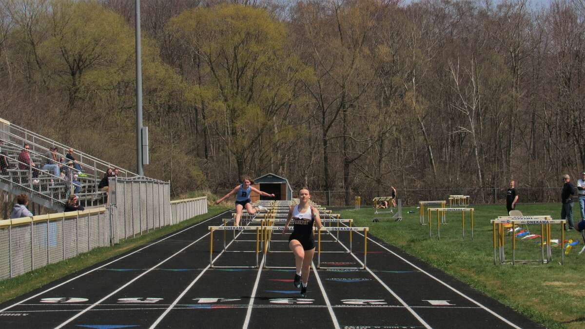 Frankfort junior Presley Bartley sprints to the finish line after clearing the last hurdle at the 2022 Onekama Invite on Friday, April 29 at Onekama High School