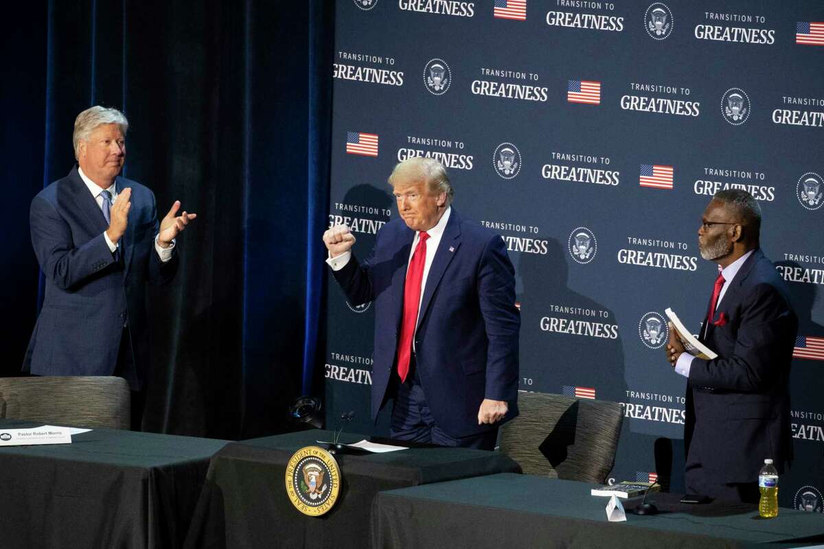 Pastor Robert Morris, left, and Bishop Harry Jackson, senior pastor at Hope Christian Church in Beltsville, Md., right, applaud after President Donald Trump spoke during a roundtable discussion about "Transition to Greatness: Restoring, Rebuilding, and Renewing," at Gateway Church Dallas Campus, Thursday, June 11, 2020, in Dallas.(AP Photo/Alex Brandon)