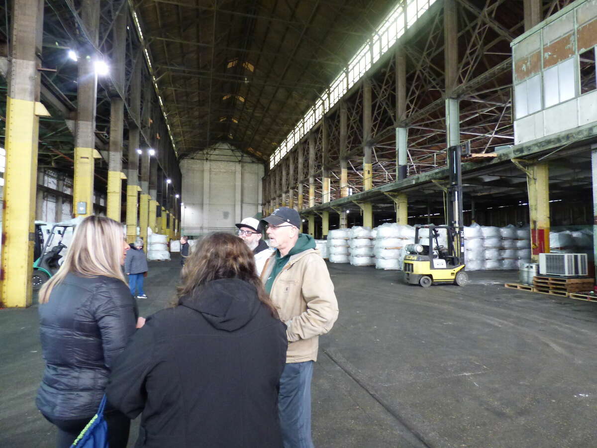 Members of the Tight Lines for Troops committee meet at the Manistee Iron Works building to prepare for the fishing tournament's return later this month. 