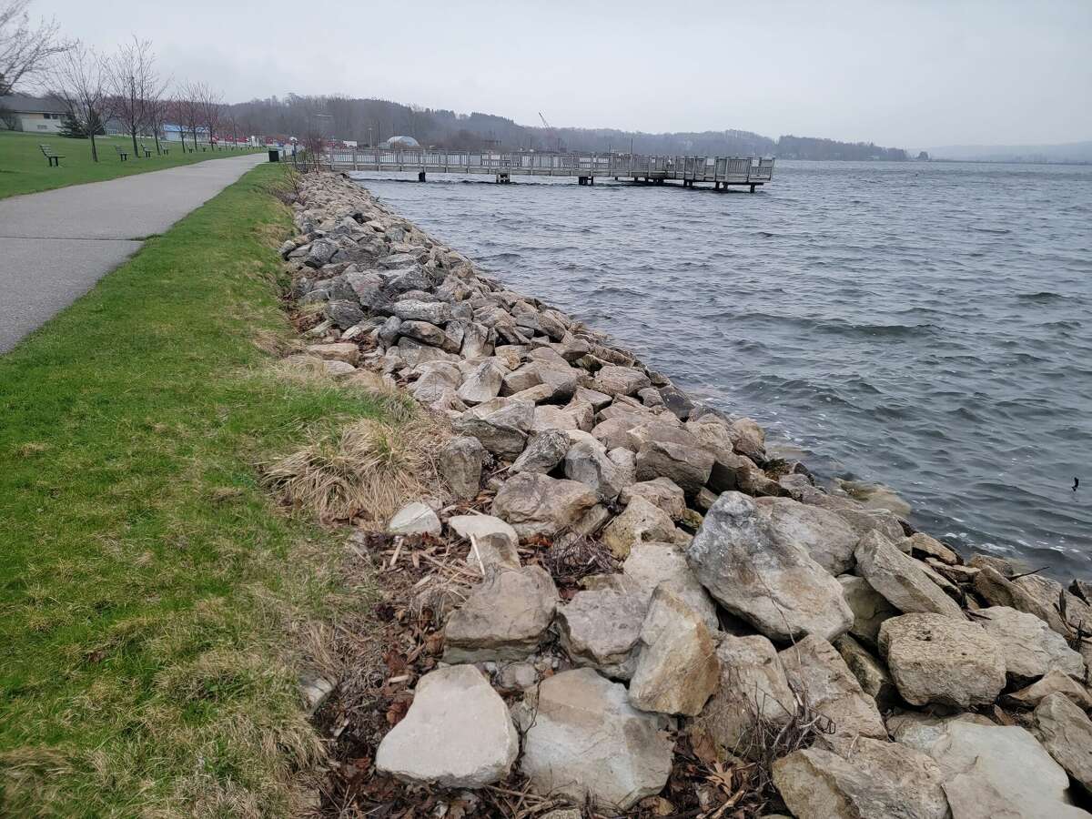 Evidence of erosion from high water levels rising over the rock barrier at Open Space Park can be seen as Lake Michigan's levels drop from the highs of 2021 and 2020.  