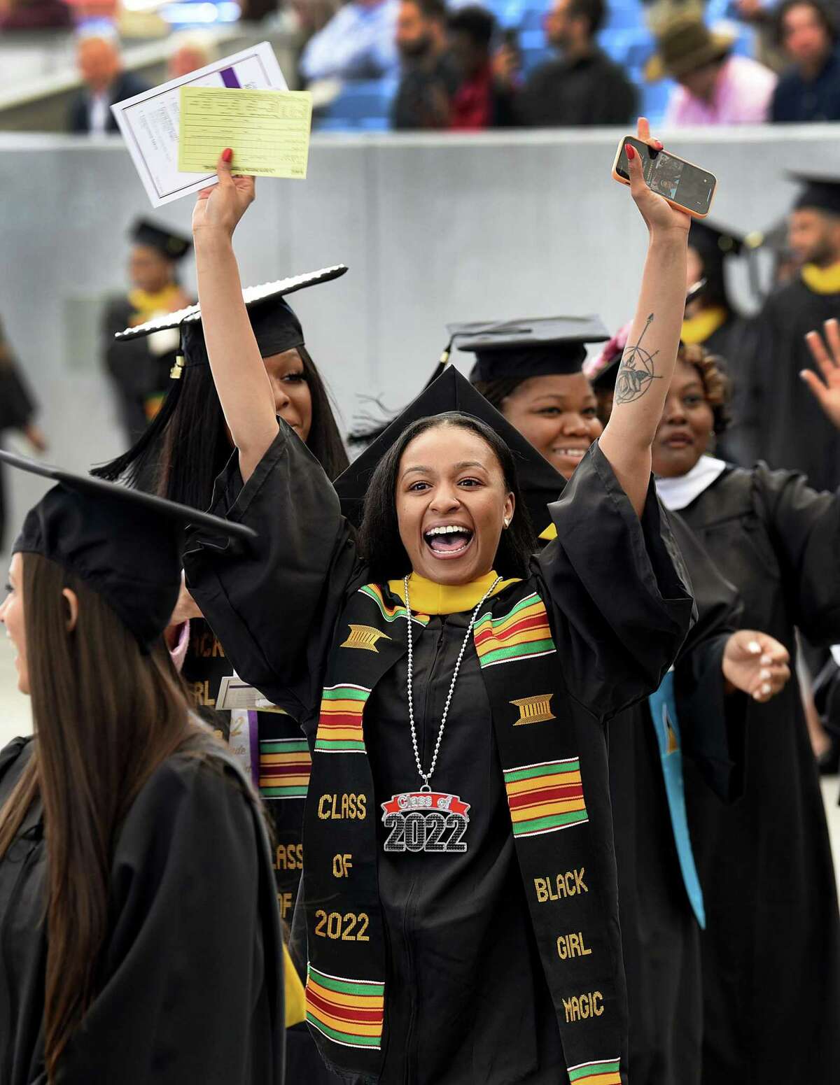 Jenayia Patterson of New Haven shows her enthusiasm during the processional at the start of graduation Sunday. The University of Bridgeport held its commencement ceremony for undergraduate students Sunday, May 1, 2022 at the Hartford HealthCare Amphitheater in Bridgeport.