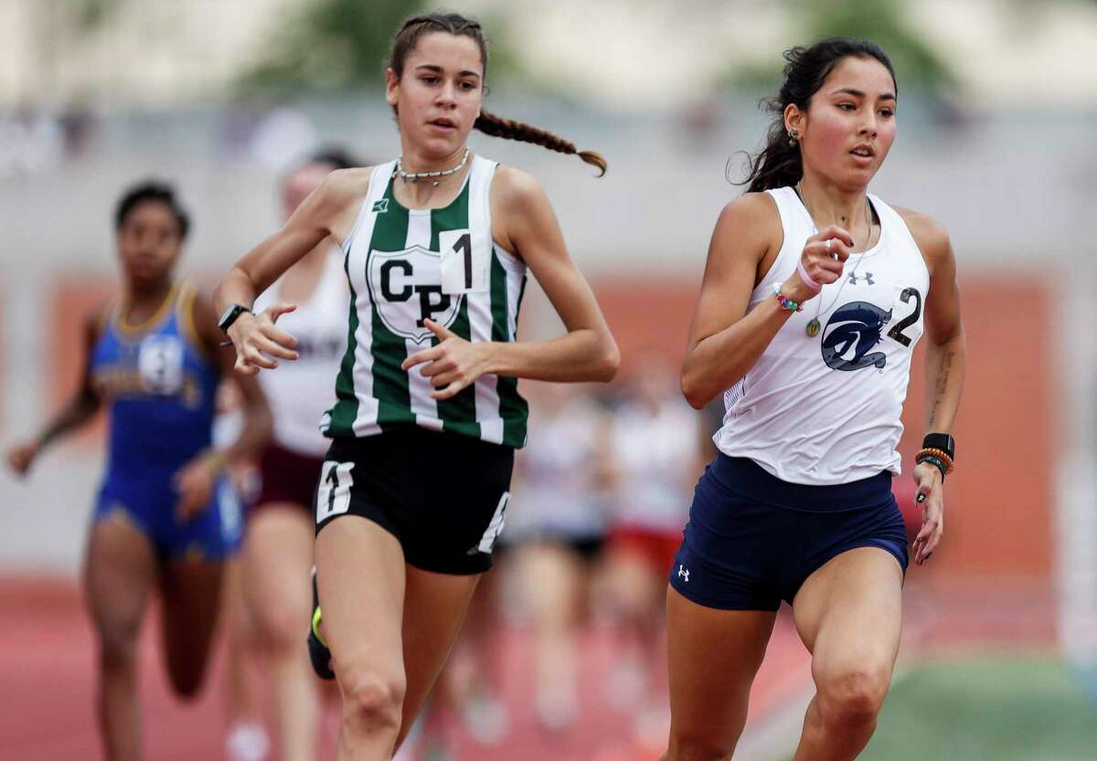 Boerne Champion senior Anastacia Gonzales, right, and Cedar Park sophomore Isabel Conde De Frankenberg, left, pull ahead of the pack during the first lap of the Region IV-5A girls 80-meter final at Heroes Stadium in San Antonio on Saturday, April 30, 2022.