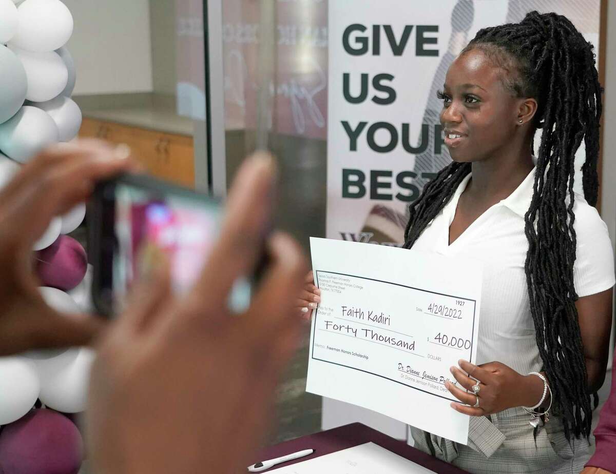 Faith Kadiri, a George Ranch High School graduate, holds up her ceremonial check during the Thomas F. Freeman Honors College Academic Signing Day event at Texas Southern University Friday, April 29, 2022, in Houston. Seven students participated in the ceremonial signing for the honors college.