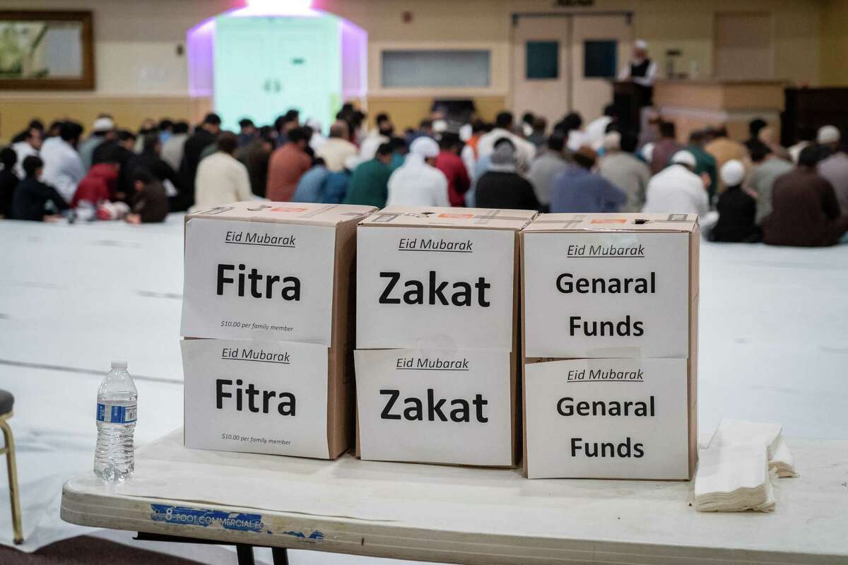 Donation boxes sit on a table at the entrance to morning prayer on Eid al-Fitr, a celebration marking the end of the month of Ramadan, on Monday, May 2, 2022, at the Pakistan Center in Houston. This year’s Zakat, which is a type of almsgiving, will go towards buying groceries for refugees from Afghanistan, said Muzaffar Siddiqi, vice president of the Pakistan Association of Greater Houston.