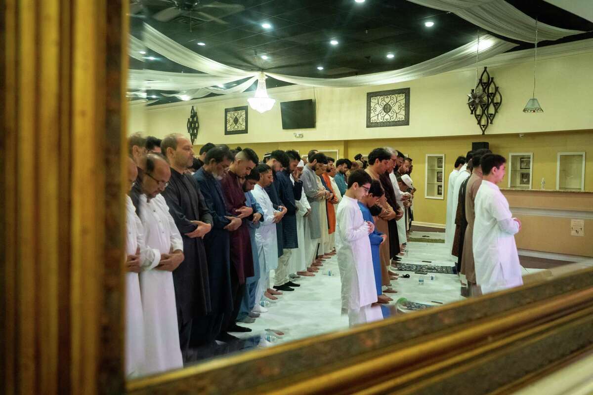 Men pray on the morning of Eid al-Fitr, a celebration marking the end of the month of Ramadan, on Monday, May 2, 2022, at the Pakistan Center in Houston.