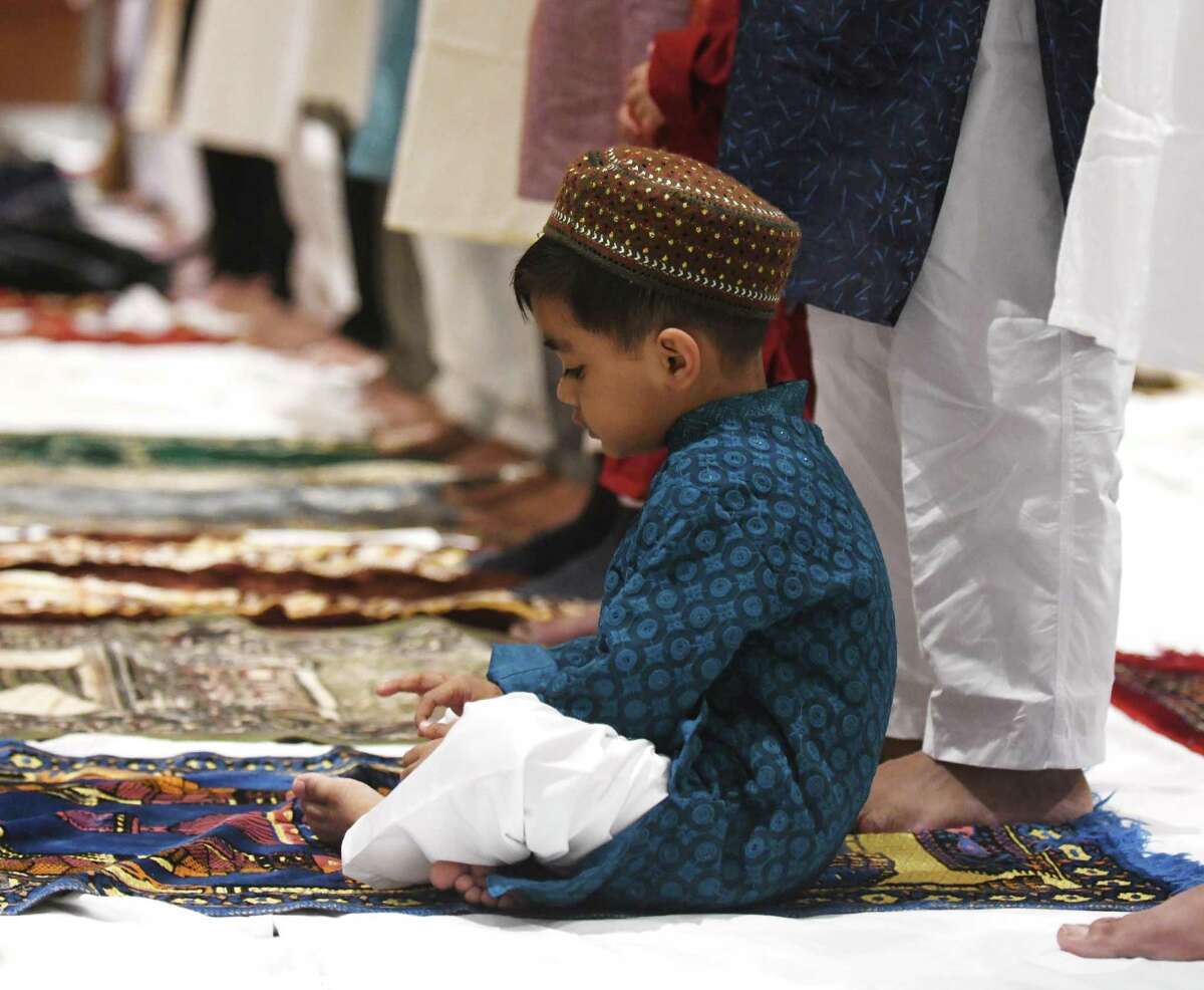 Stamford's Adhil Hamid participates in the Eid al-Fitr prayer ceremony at the Hilton Hotel & Executive Meeting Center in Stamford, Conn. Monday, May 2, 2022. Presented by the Stamford Islamic Center, hundreds of Muslims gathered to break the fast and mark the end of the holy month of Ramadan.
