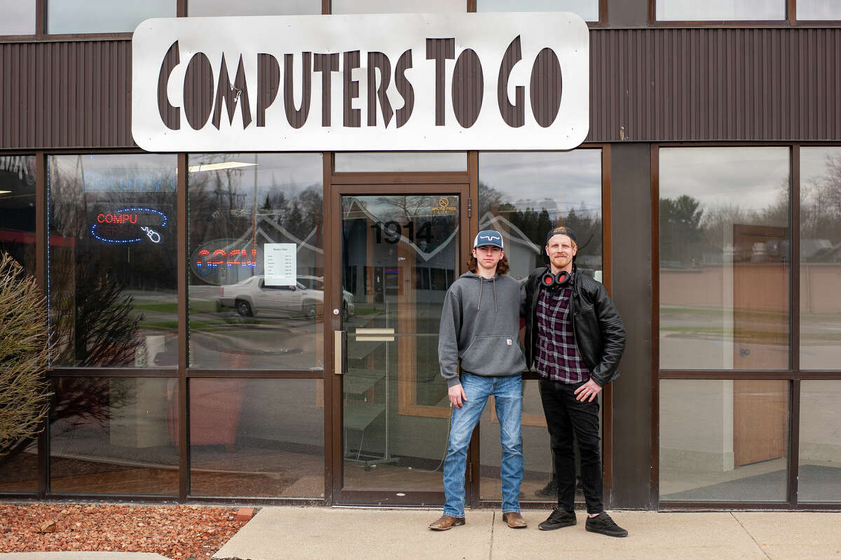 Computers to Go intern Brendan Giardina (left) and owner Zac Mularz pose outside the business's new location on May 2, 2022 at 1914 S. Saginaw Road.