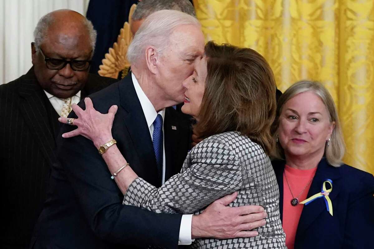 President Joe Biden kisses House Speaker Nancy Pelosi, D-Calif., during an Affordable Care Act event in the East Room of the White House in Washington, Tuesday, April 5, 2022. 