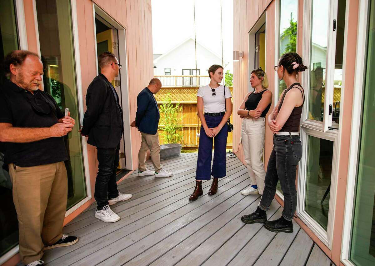 Rice architecture students Madeleine Pelzel, Kati Gullick, center, and Alexandra Oetzel, talk with Andrew Colopy and Danny Samuels, co-directors of Rice Architecture Construct at the Accessory Dwelling Unit built by those Rice architecture students at 1914 Summer Street in First Ward on Tuesday, April 26, 2022 in Houston. The 620 square foot home was a hands-on home that allowed Rice students to put book learning to work. They also help address the shortage of affordable housing.