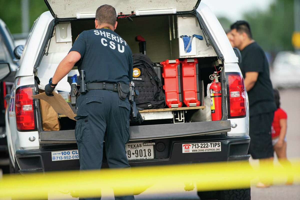 An investigator prepares to collect evidence at the scene of a shooting in west Harris County where authorities say two children found an unsecured handgun which discharged, striking a four-year-old in the head, Monday, May 2, 2022, at in Houston. The four-year-old is currently in critical condition.