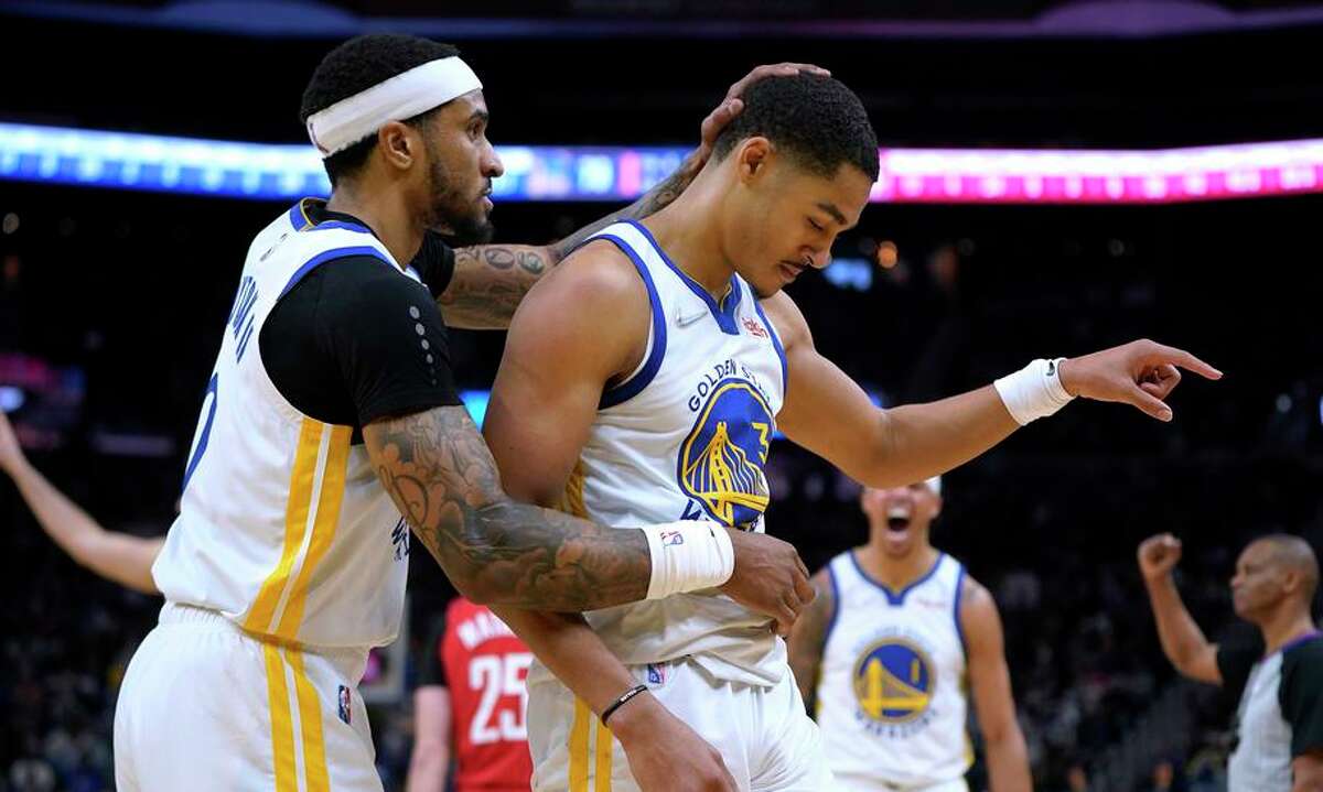 Golden State Warriors guard Jordan Poole, right, is congratulated by guard Gary Payton II after scoring and being fouled during the second half of the team's NBA basketball game against the Houston Rockets in San Francisco, Friday, Jan. 21, 2022. (AP Photo/Jeff Chiu)