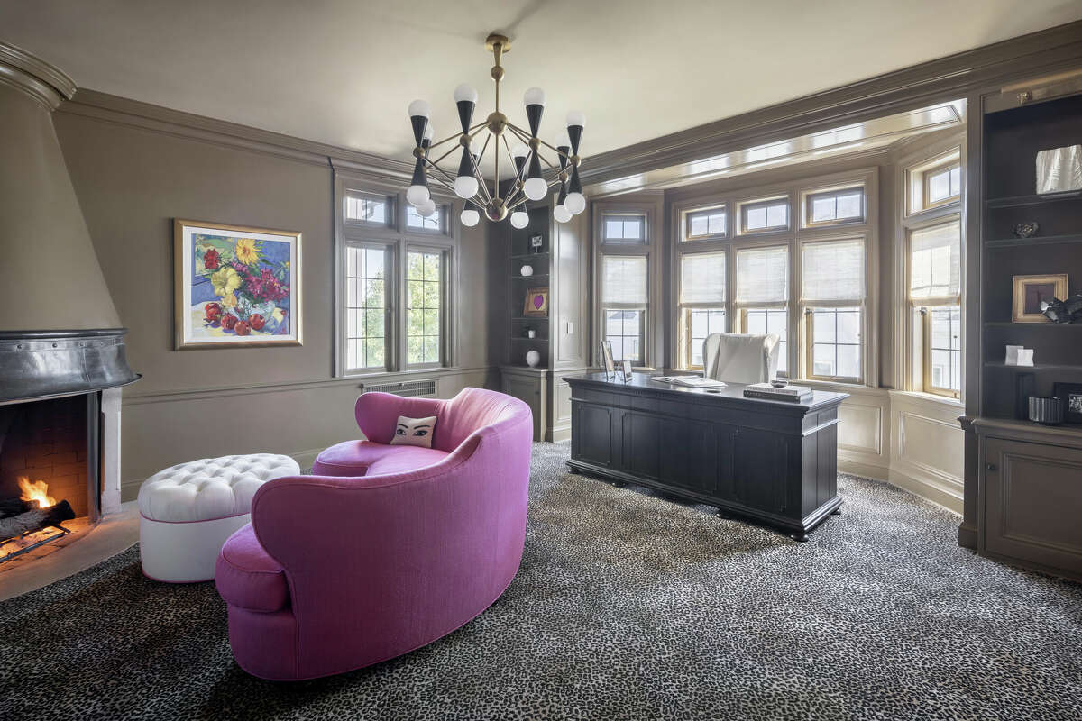 The home's office has it's own hearth as well as built-in bookshelves. 