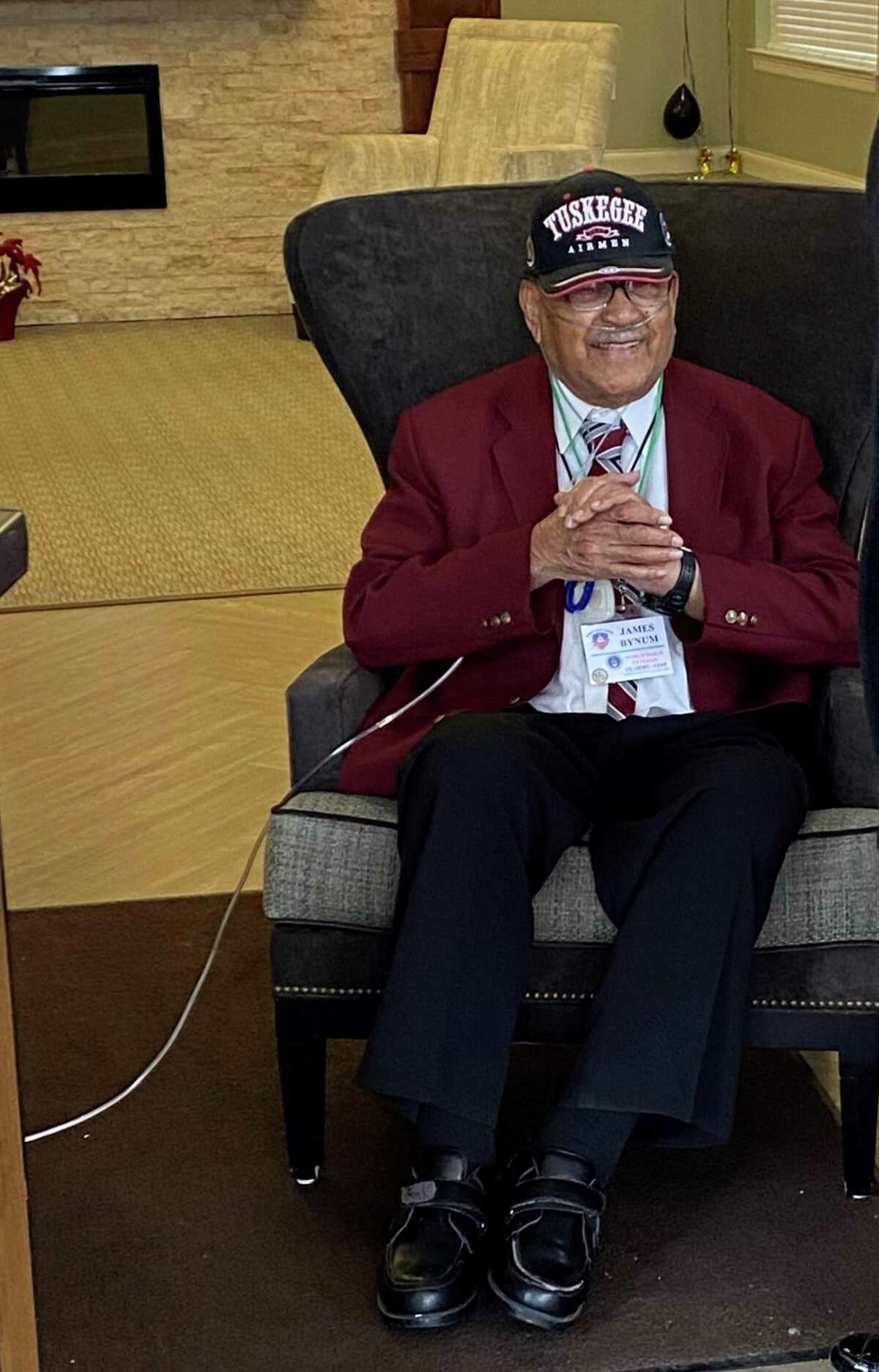 James Bynum, a Tuskegee Airman, is surprised by a car parade celebrating his 100th birthday at his Northwest Side assisted living residence.