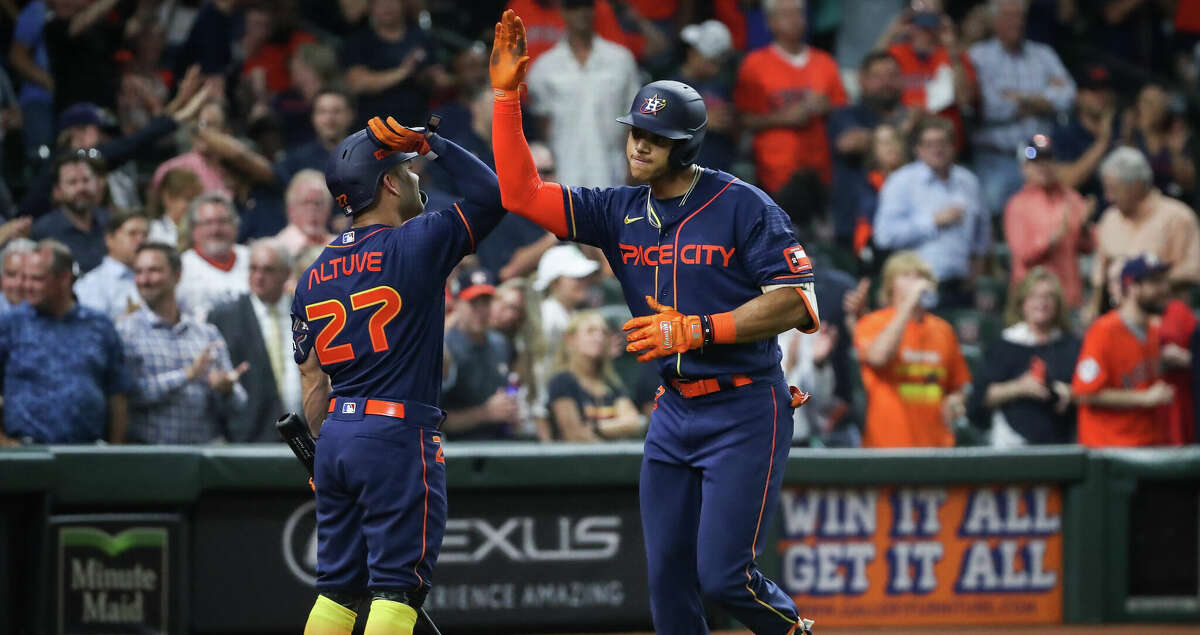 Houston Astros shortstop Jeremy Pena (3) celebrates with second baseman Jose Altuve (27) after he hit a two-run home run during the sixth inning of an MLB game Monday, May 2, 2022, at Minute Maid Park in Houston.