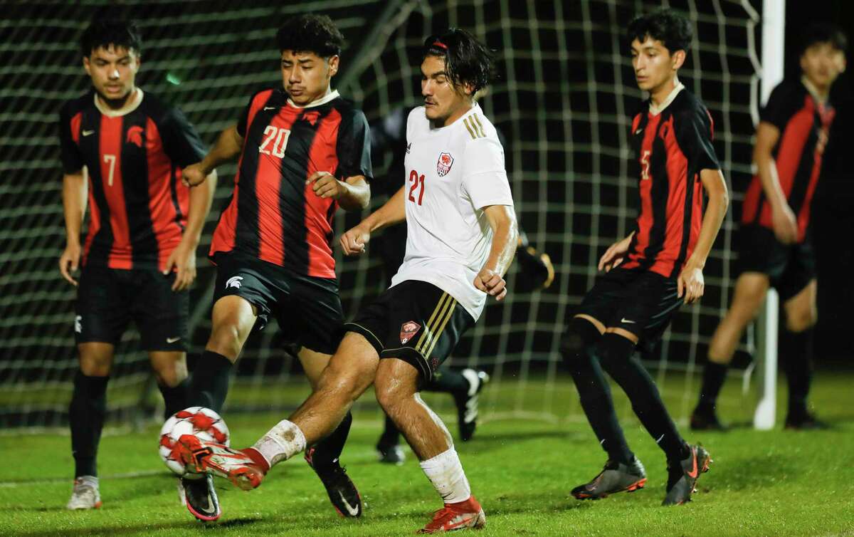 Caney Creek’s Mario Leon (21) makes a pass in front of Porter’s Abelardo Lopez (20) during the second period of a high school soccer match at Porter High School, Tuesday, Feb. 1, 2022, in Porter.