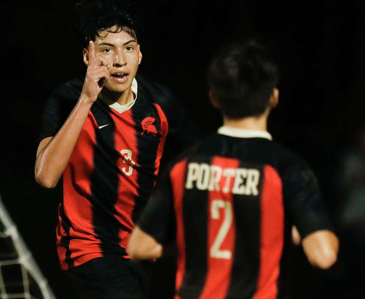 Porter’s Luis Marquez (9) reacts after scoring the game-winning goal during the second period of a high school soccer match at Porter High School, Tuesday, Feb. 1, 2022, in Porter. Marquez scored both of the Spartans’ goals in the team’s 2-1 win over Caney Creek.
