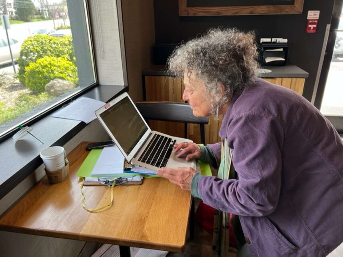 Ruth Pelham looks over spreadsheets of oral histories and videos about Music Mobile, which entertained more than 10,000 kids across Albany’s urban parks each summer with sing-alongs, homemade jingle sticks percussion and messages of peace and hope.