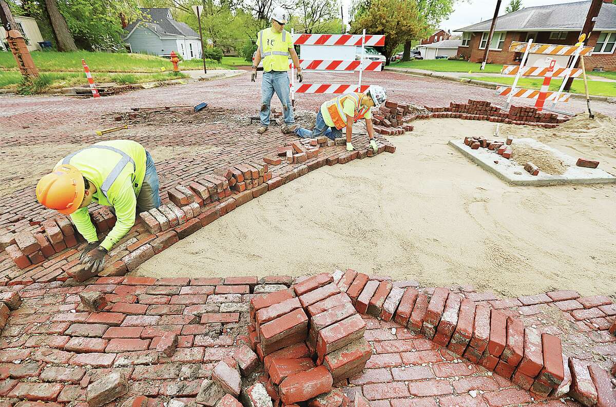 John Badman|The Telegraph It was out with the new and in with the old Tuesday on streets effected by Illinois American Water Company's efforts to progress the sewer separation project up Alby Street and connecting side roads. 