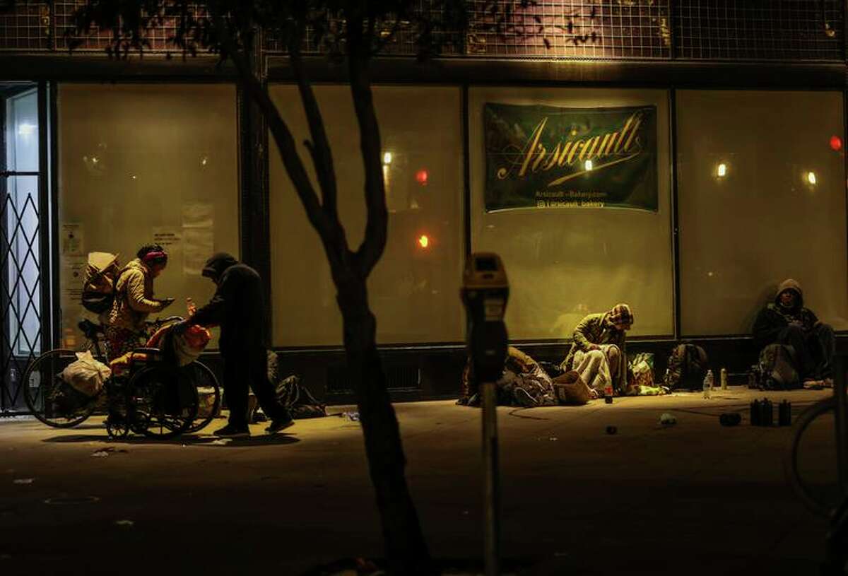 People sit outside of Arsicault bakery on March 31, 2022 in San Francisco.