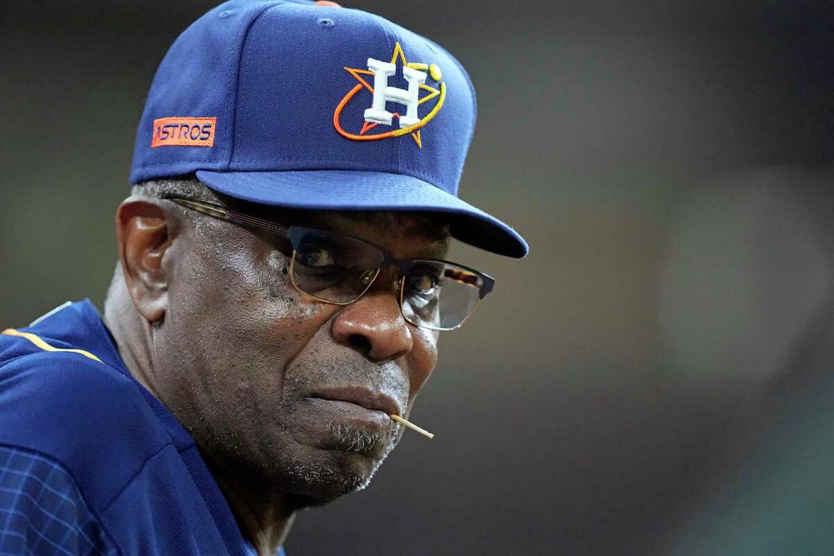 Houston Astros manager Dusty Baker Jr. watches from the dugout during the sixth inning of a baseball game against the Seattle Mariners Monday, May 2, 2022, in Houston. (AP Photo/David J. Phillip)