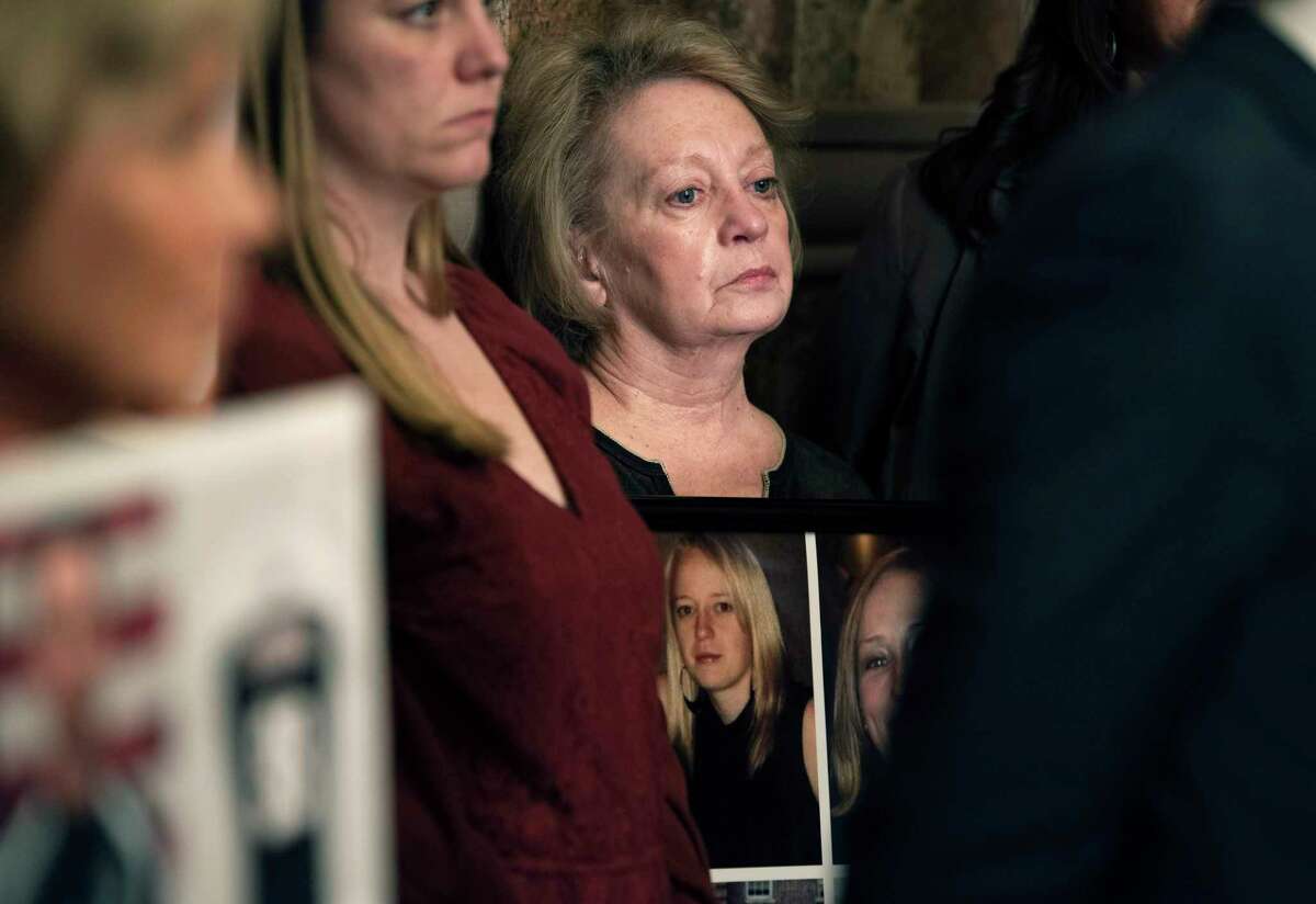 Linda King holds a framed collage containing the photos of her four daughters, Abby Jackson, Mary Dyson, Allison King, and Amy Steenburg, during a press conference held to call on lawmakers to pass The Grieving Families Act on Tuesday, May 3, 2022, in Albany, N.Y. The four sisters all died in the Schoharie limo crash. Standing next to King is Jamison Ott, who was best friends with the four women. (Paul Buckowski/Times Union)