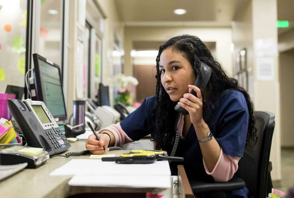 A health services specialist Lisette Hamilton works on rescheduling patient appointments at Planned Parenthood Redwood City Health Center in Redwood City in 2017. If the U.S. Supreme Court overturns Roe v Wade, women from out of state could flood into California seeking abortions.
