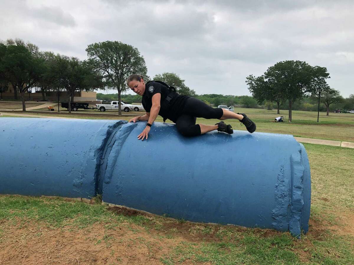 San Antonio Police Detective Jessica Aelvoet runs an obstacle course Tuesday morning. The police department is hosting a Women in Policing event Saturday in an effort to recruit more women to the force.