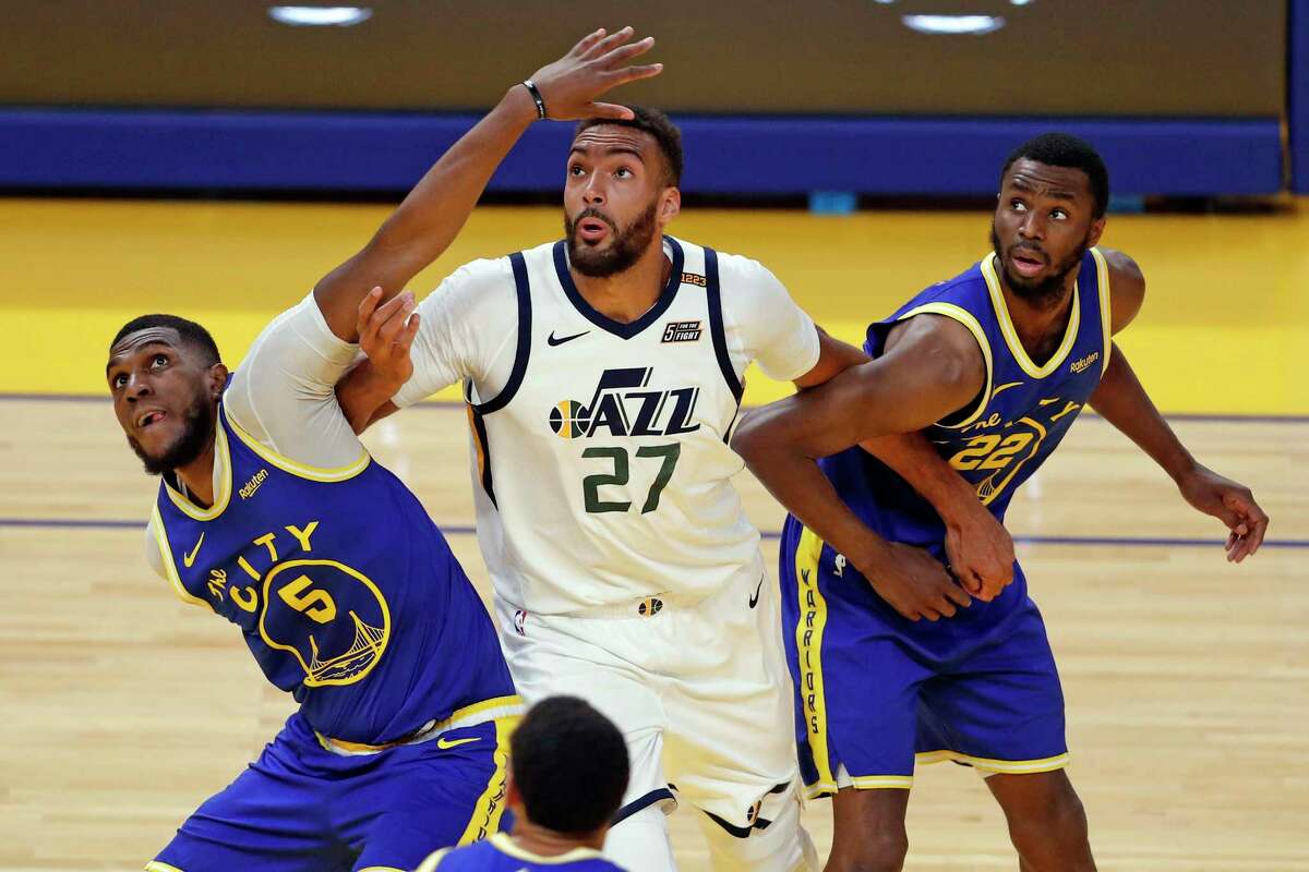 Could the Golden State Warriors trade Andrew Wiggins for Rudy Gobert? Golden State Warriors' Kevon Looney and Andrew Wiggins battle Utah Jazz' Rudy Gobert for rebound position during 1st quarter of NBA game at Chase Center in San Francisco, Calif., on Monday, May 10, 2021.