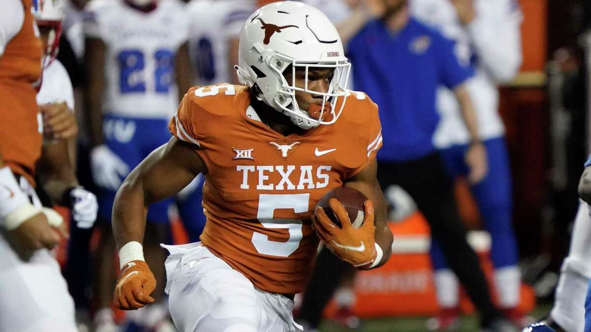 Texas running back Bijan Robinson (5) runs against Kansas during the first half of an NCAA college football game in Austin, Texas, Saturday, Nov. 13, 2021. (AP Photo/Chuck Burton)