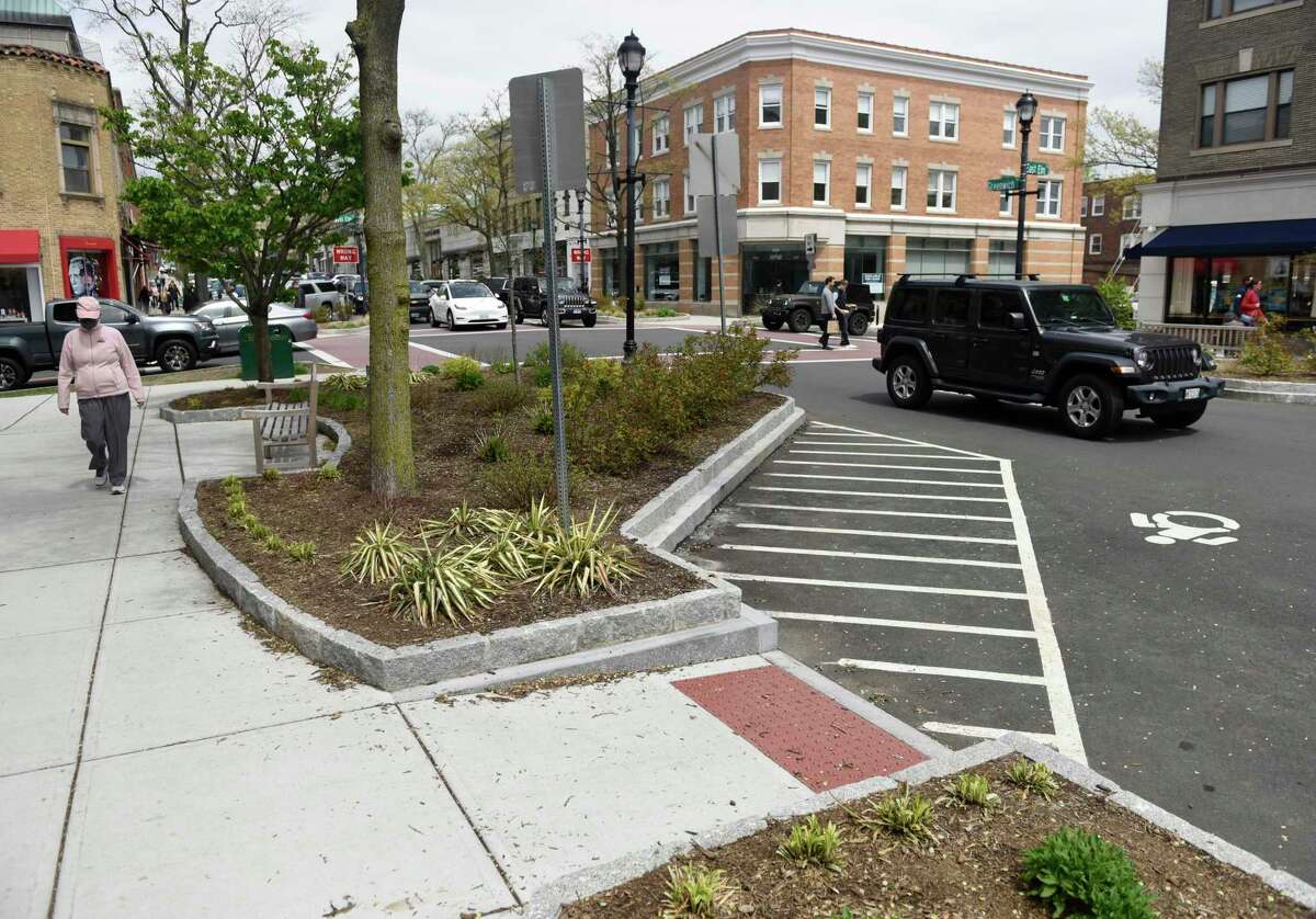 Traffic and pedestrians pass through the sidewalk bumpout at the intersection of Greenwich Avenue and Elm Street in Greenwich, Conn. Tuesday, May 3, 2022. A plan to add bumpouts at another intersection will be debated by the RTM.