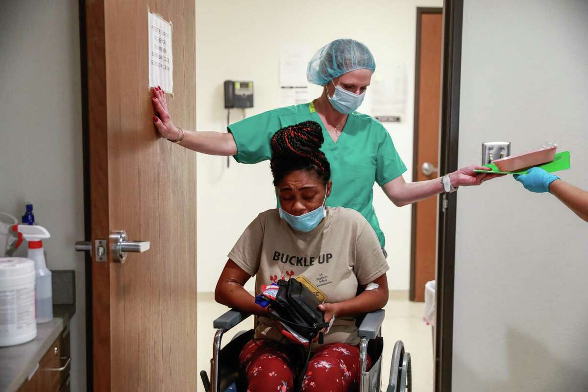 Volunteer Jennifer Goodner (top) helps patient Judith, 33, in a wheelchair after getting a surgical abortion at the Trust Women’s clinic on Thursday, Sept. 9, 2021 in Oklahoma City, Oklahoma. Judith had to travel over six hours from Houston, Texas to get the procedure. Judith suffers from Type 1 diabetes and her partner with whom she shares four kids with suffers from kidney failure. She said, “ I am sick. Why would I want to bring kids into this world? I know that if I’m gone no one can mother them like I do.” Judith’s 35-year old sister died of diabetes a week prior and she planned to drive directly to Louisiana after the abortion for her funeral.