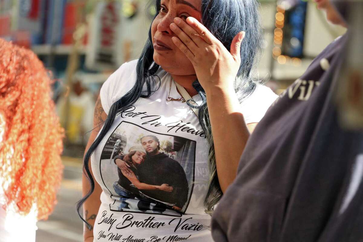In the aftermath of last weekend’s mass shooting that killed 6 people, Tamika Young, sister of victim Devazia Turner, wipes away a tear at the scene of her brother’s death at 10th and K in Sacramento, Calif., on Tuesday, April 5, 2022.