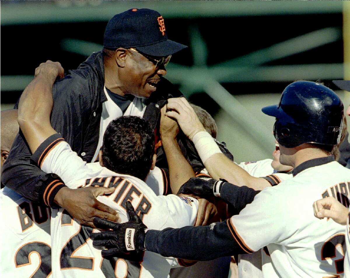 SAF03:SPORT-BASEBALL:SAN FRANCISCO, 18SEP97 - San Francisco Giants manager Dusty Baker is hoisted up in celebration by Barry Bonds (L), Stan Javier (C), and Rich Aurilia (R) after a dramatic 12th inning victory over the Los Angeles Dodgers at 3COM Park, September 18. The Giants' Brian Johnson hit his 10th home run of the season off the Dodgers' relief pitcher Mark Guthrie for the 6-5 victory, moving the Giants and Dodgers into a tie in the National League West. cbm/Photo by Clay McLachlan REUTERS