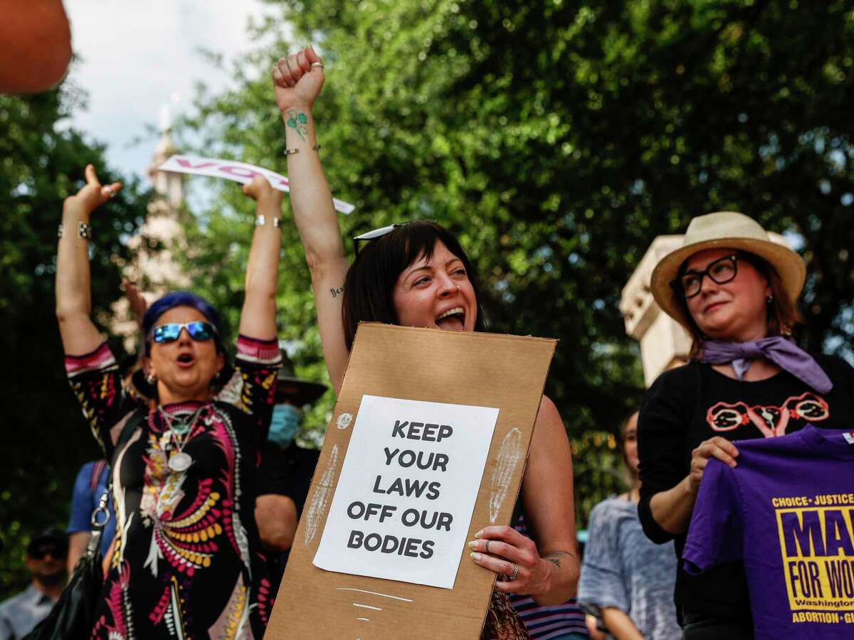 Lauren Moore, center, of Austin and other abortion rights activists gather outside of the Texas State Capitol Tuesday, May 3, 2022 in Austin for an “emergency protest” in Austin, Texas. The protest was organized by Rainbow Coalition Austin and Texas Rise Up 4 Abortion Rights as a reaction to a leaked opinion draft from the Supreme Court that shows the court plans to overturn Roe v. Wade.