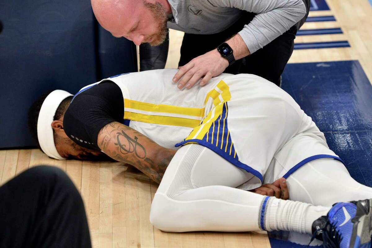 Golden State Warriors guard Gary Payton II (0) lies on the court after being fouled in the first half during Game 2 of a second-round NBA basketball playoff series against the Memphis Grizzlies Tuesday, May 3, 2022, in Memphis, Tenn. (AP Photo/Brandon Dill)