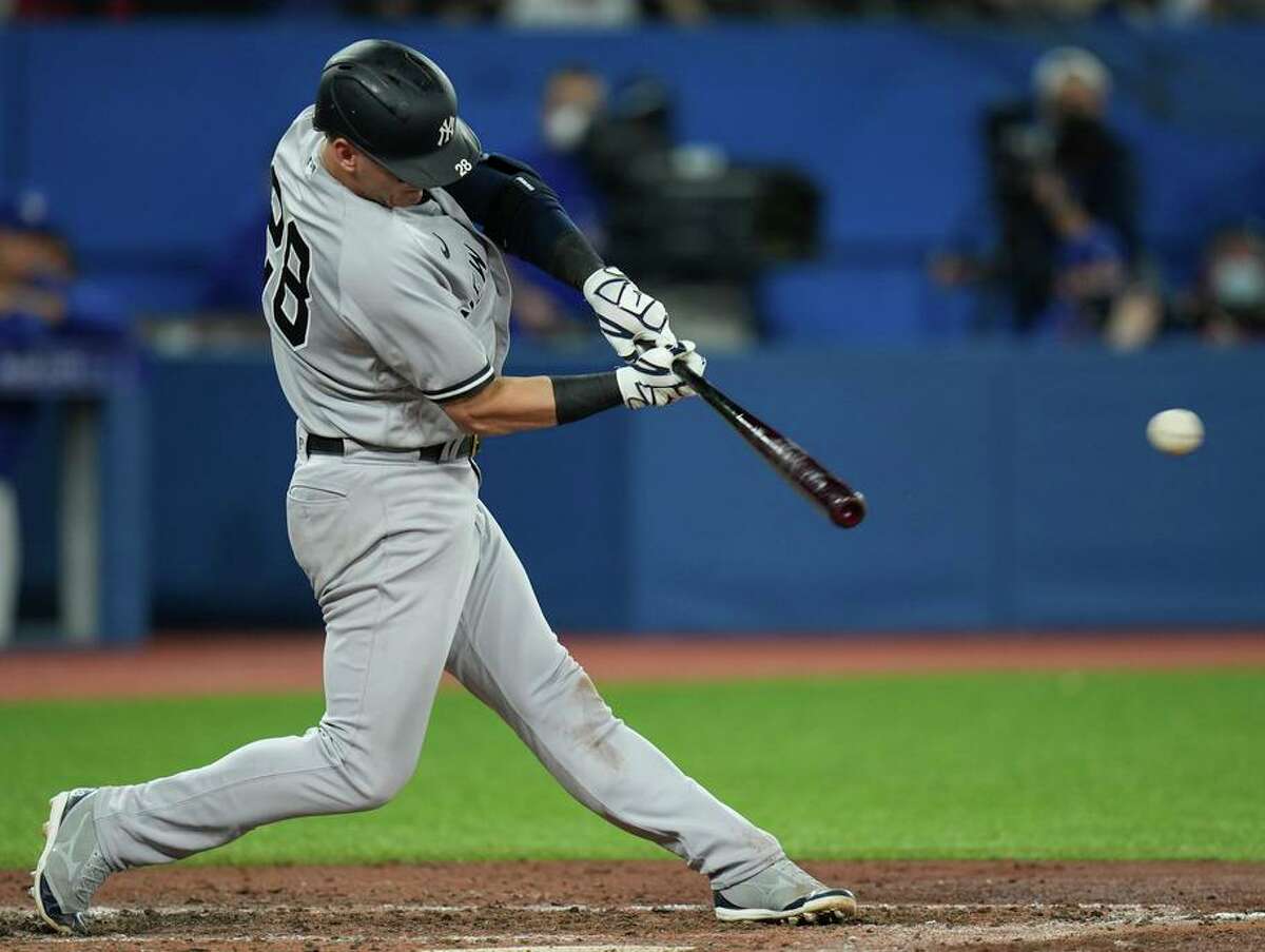 New York Yankees' Josh Donaldson hits an RBI double against the Toronto Blue Jays during the seventh inning of a baseball game Tuesday, May 3, 2022, in Toronto. (Nathan Denette/The Canadian Press via AP)