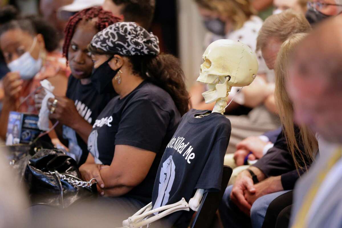 A prop skeleton with “Creosote Killed Me” t-shirt is placed in the middle of the seating during a community meeting put on by the Texas Commission on Environmental Quality, held at the DeLUXE Theater Tuesday, May 3, 2022 in Houston, TX.
