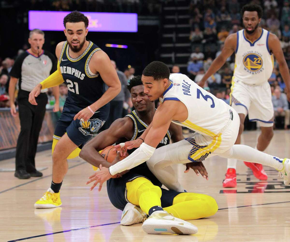 Jordan Poole (3) tussles for a loose ball with Jaren Jackson Jr. (13) In the first half as the Golden State Warriors played the Memphis Grizzlies in Game 2 of the second round of the NBA Playoffs at Fedex Forum in Memphis, Tenn., on Tuesday, May 3, 2022.
