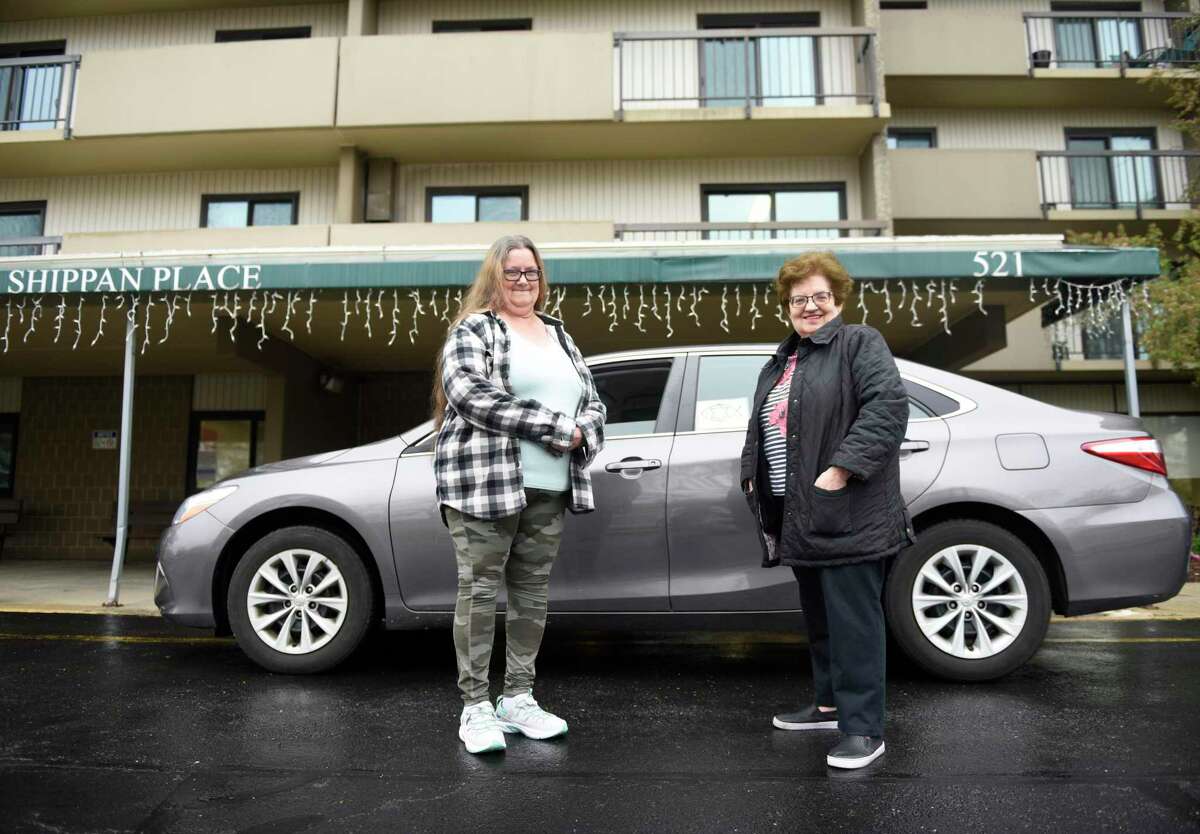 FISH of Stamford client Mary Ann Novak, left, poses with FISH volunteer driver Cheryl Kendall outside her apartment in Stamford, Conn. Tuesday, April 26, 2022. FISH is a local organization that provides free rides to Stamford residents for medical appointments. The organization is celebrating 50 years in operation this year.