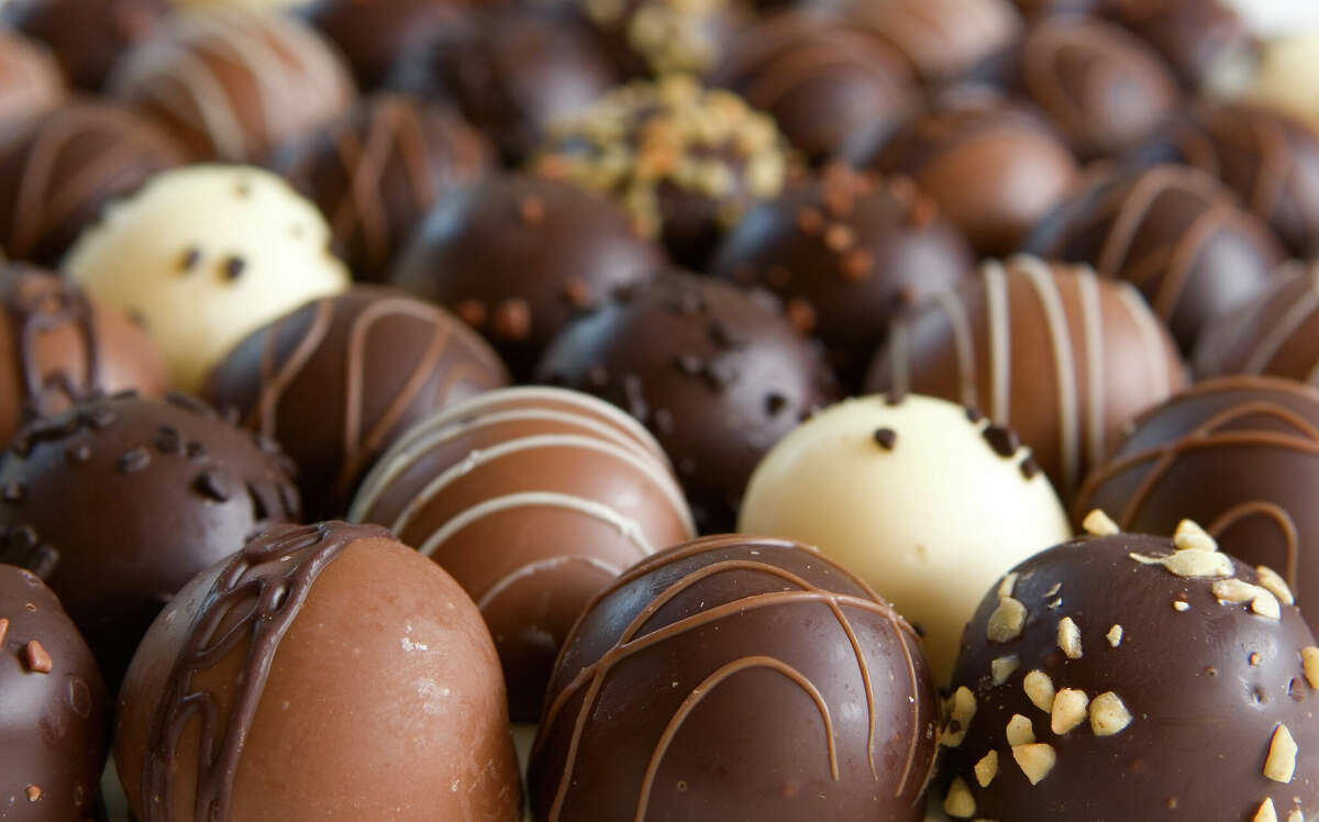 Chocolate truffle candy background - focus only on front truffles