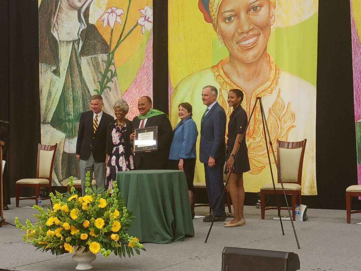 Martin Luther King III takes a photo after receiving an honorary Doctor of Humane Letters at Siena College. 