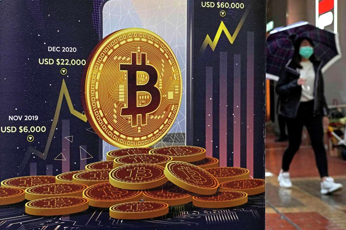 An advertisement for bitcoin cryptocurrency is displayed on a street in Hong Kong. California on Wednesday became the first state to formally begin examining how to adapt to cryptocurrency and related technologies, following in the path laid out by President Joe Biden in March.