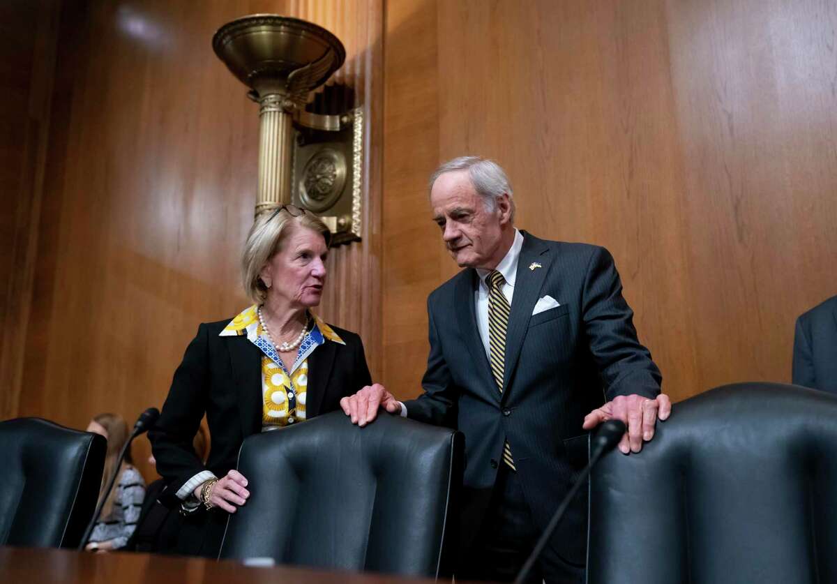 Sen. Shelley Moore Capito, R-W.Va., the ranking member, left, and Sen. Tom Carper, D-Del., chairman of the Senate Committee on Environment and Public Works, confer during a business meeting to advance the Water Resources Development Act of 2022, at the Capitol in Washington, Wednesday, May 4, 2022. (AP Photo/J. Scott Applewhite)
