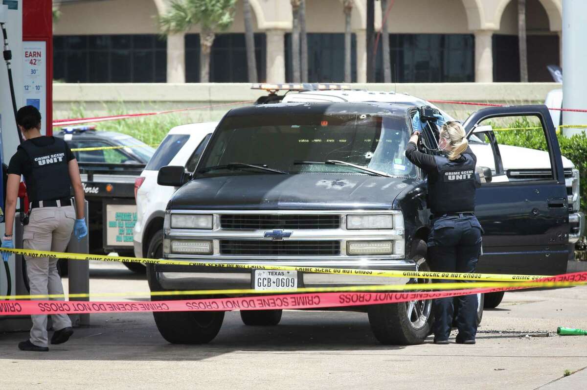 Authorities investigate the scene of a reported officer-involved shooting Wednesday, May 4, 2022, in the 14300 block of the Gulf Freeway in Houston.