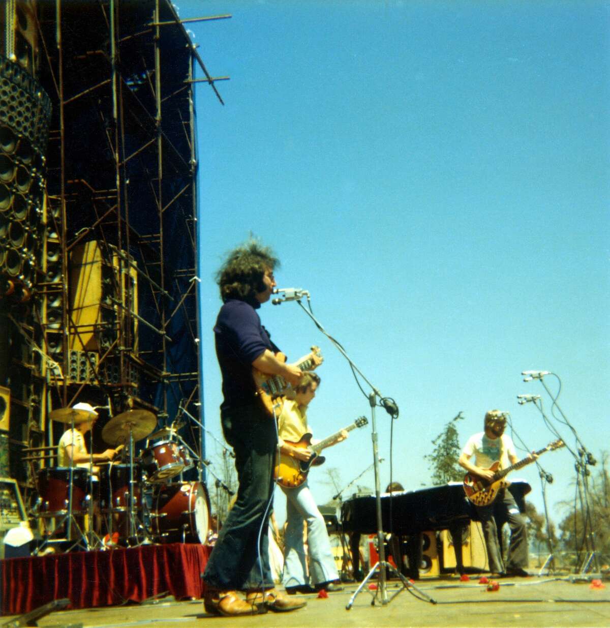 The Grateful Dead (L to R: Bill Kreutzmann, Jerry Garcia, Bob Weir, Phil Lesh) perform on May 25, 1974 at Santa Barbara Stadium in Santa Barbara, California with an early version of their Wall of Sound.