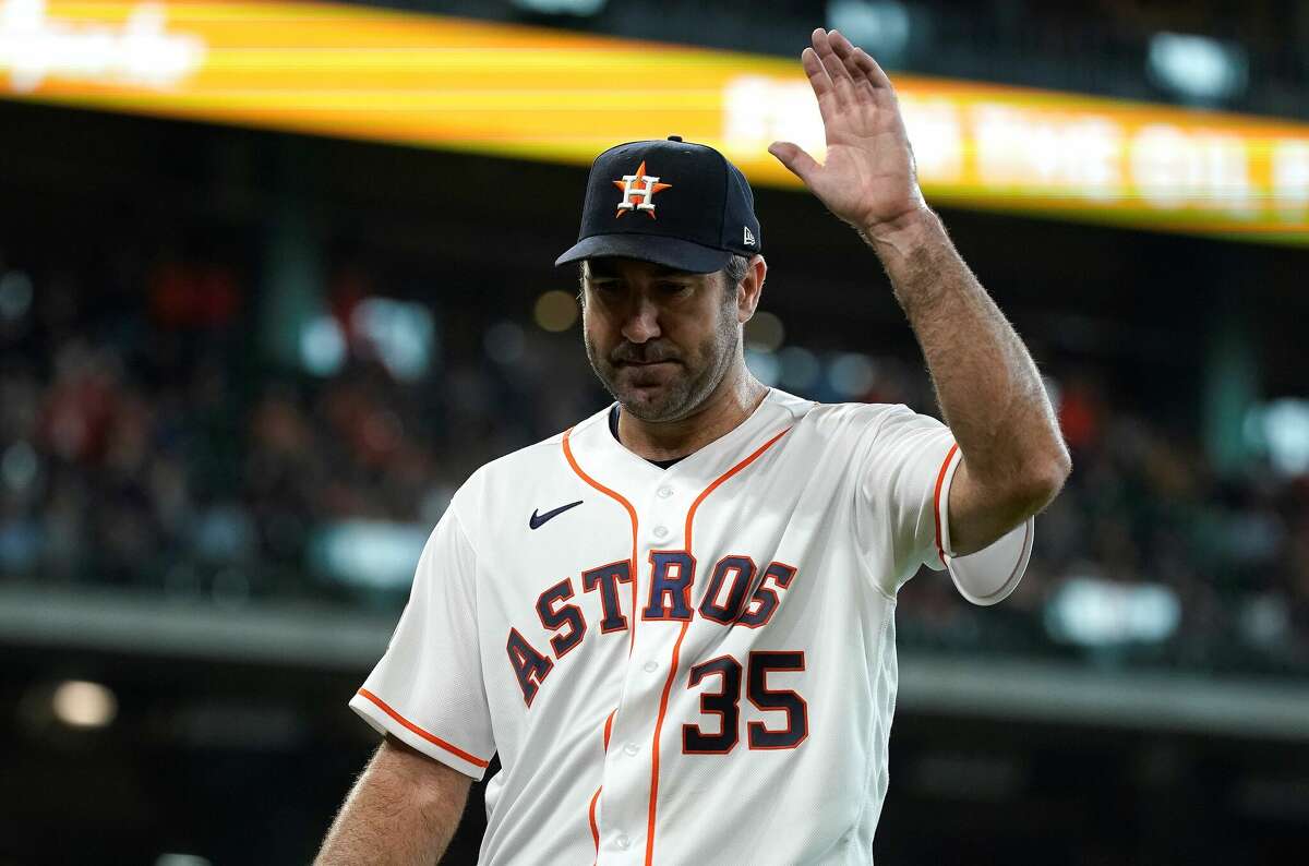 Houston Astros starting pitcher Justin Verlander (35) waves to the crowd as he walked back to the dugout after being pulled by manager Dusty Baker Jr. (12) during the seventh inning of an MLB baseball game at Minute Maid Park on Wednesday, May 4, 2022 in Houston.