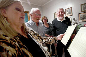 Peter and Paul Remsen react as Ice House Museum curator Susan Kilcrease reads from a letter penned by their grandfather John Henry Kirby while giving them a tour of the Kirby exhibit in Silsbee Thursday, April 28. It's the museum's newest exhibit, displaying artifacts of lumber tycoon John Henry Kirby. Kirby was discovered to be the Remsen's biological grandfather, and they are the only living direct male heirs of the man who helped put Silsbee on the map, amassing a vast fortune before being wiped out in the Great Depression. The trip to Silsbee was the brothers' first, and offered a chance to learn more about their true grandfather. Photo made Thursday April 28, 2022. Kim Brent/The Enterprise